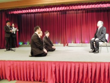 青年会議所を卒業した3人が入会式のため正座している様子